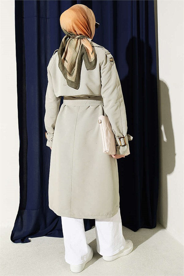 Double-breasted trench coat with epaulets, light green.
