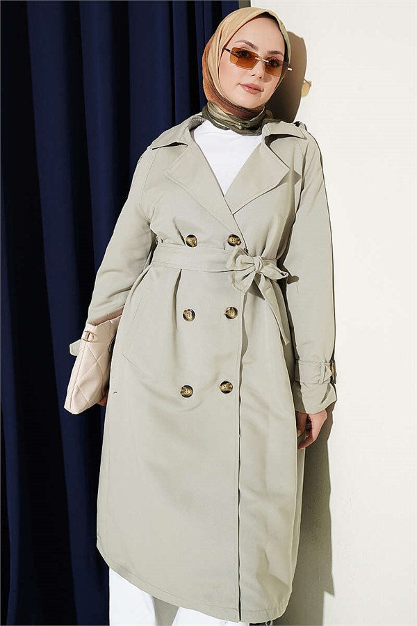 Double-breasted trench coat with epaulets, light green.