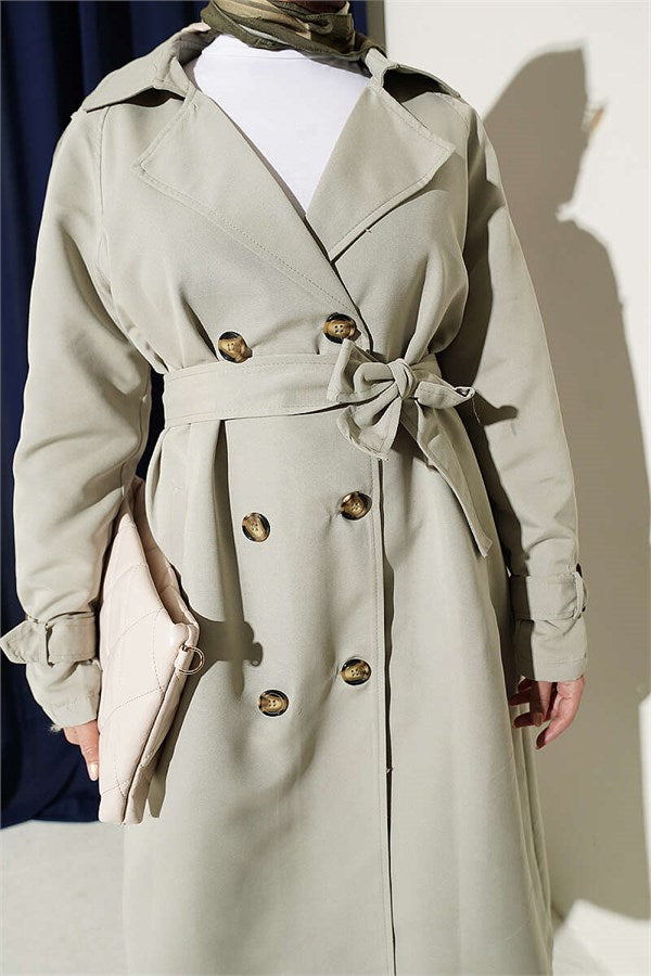 Double-breasted trench coat with epaulets, light green.