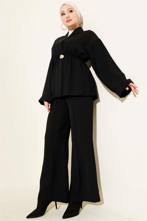 2 Piece Set in black with elastic waistband and gold accessories.