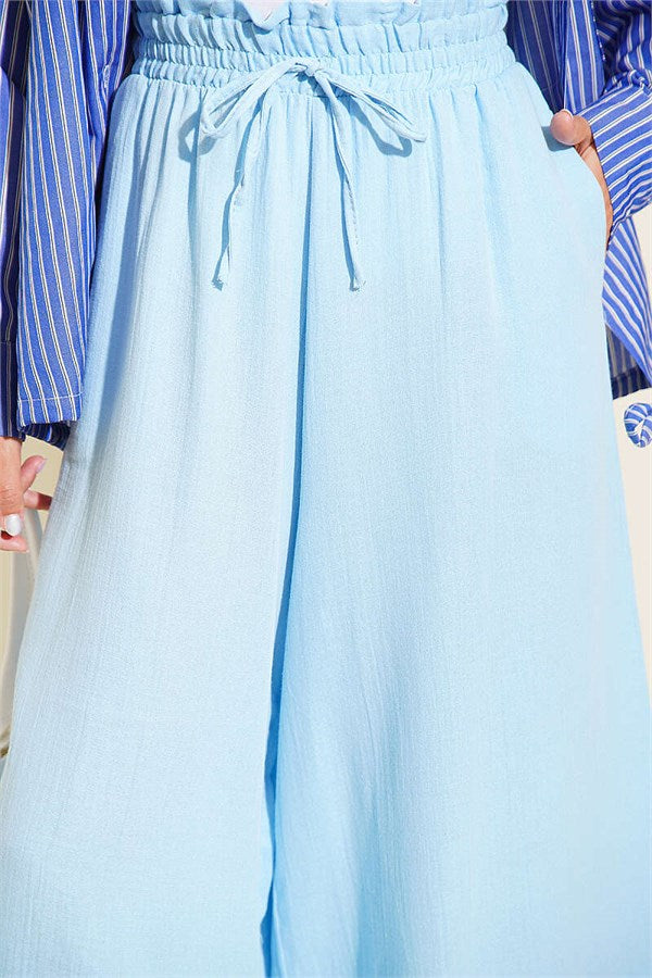Loose-fitting muslin trousers with elastic waistband, blue.