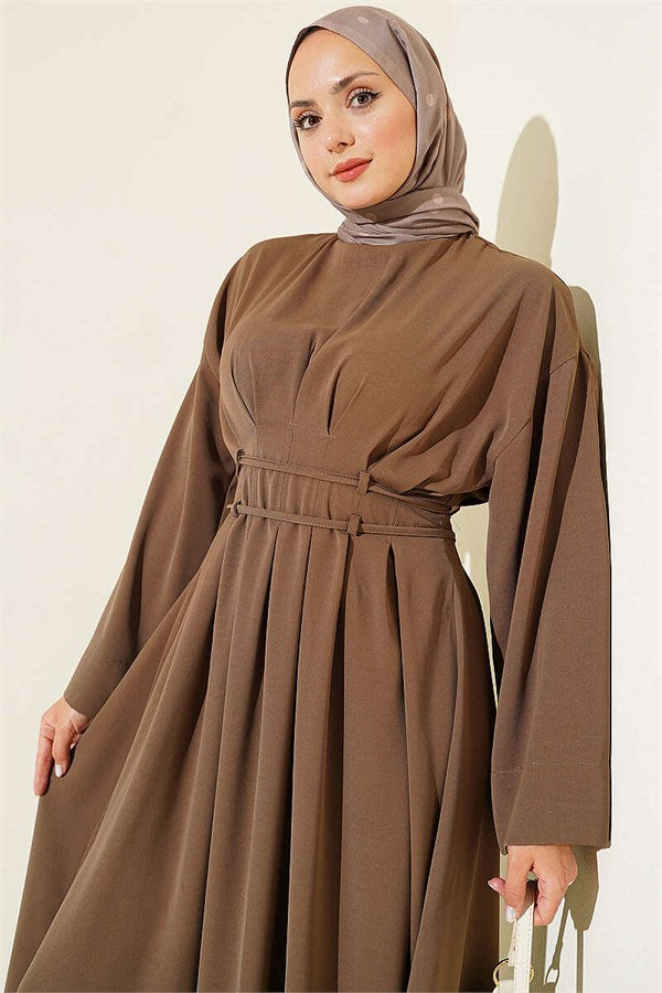 Mink-colored dress with darts and strap detail.