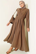 Mink-colored dress with darts and strap detail.