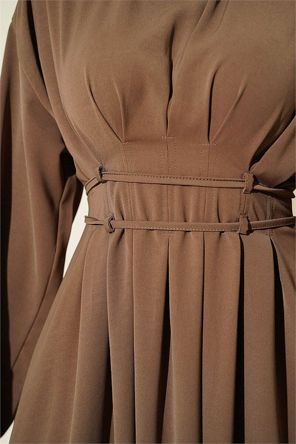 Mink-colored dress with darts and strap detail.