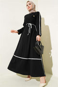 Black Dress with Floral Accessory and Piping Detail
