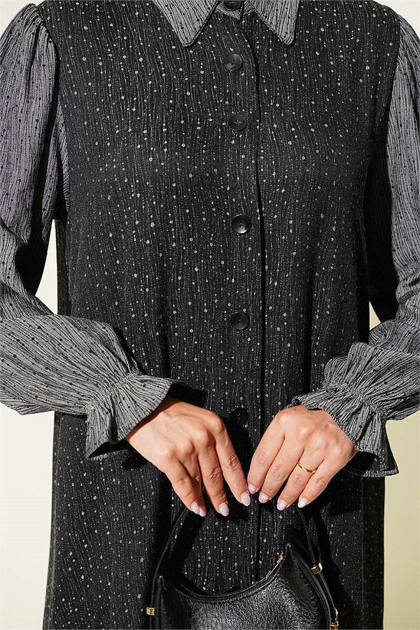 Loose-fitting, button-down dress in black.