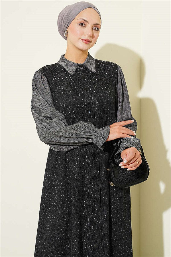 Loose-fitting, button-down dress in black.