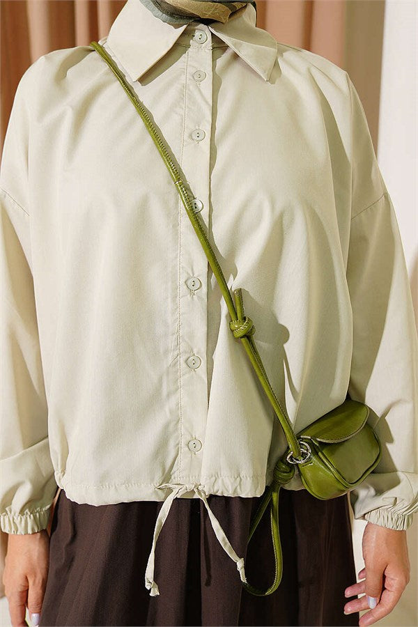 Loose-fitting shirt with tunnel hem, aqua green.