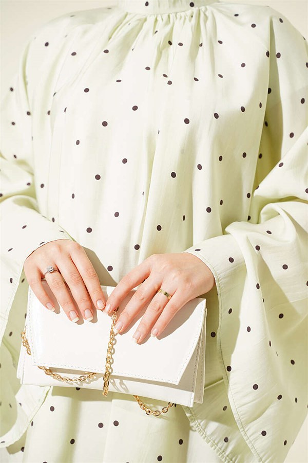 Loose-fitting tunic with wide sleeves and polka dot pattern, aqua green.