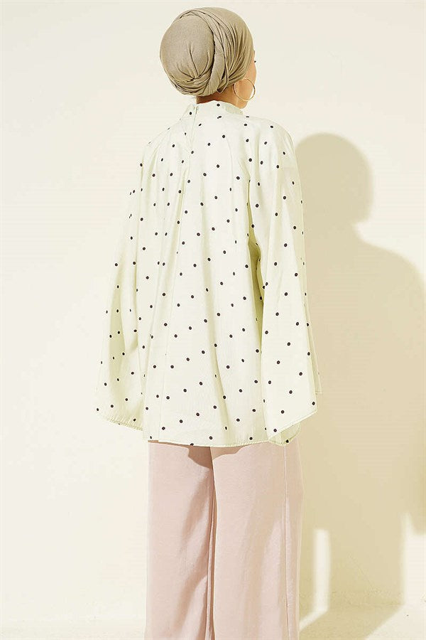 Loose-fitting tunic with wide sleeves and polka dot pattern, aqua green.
