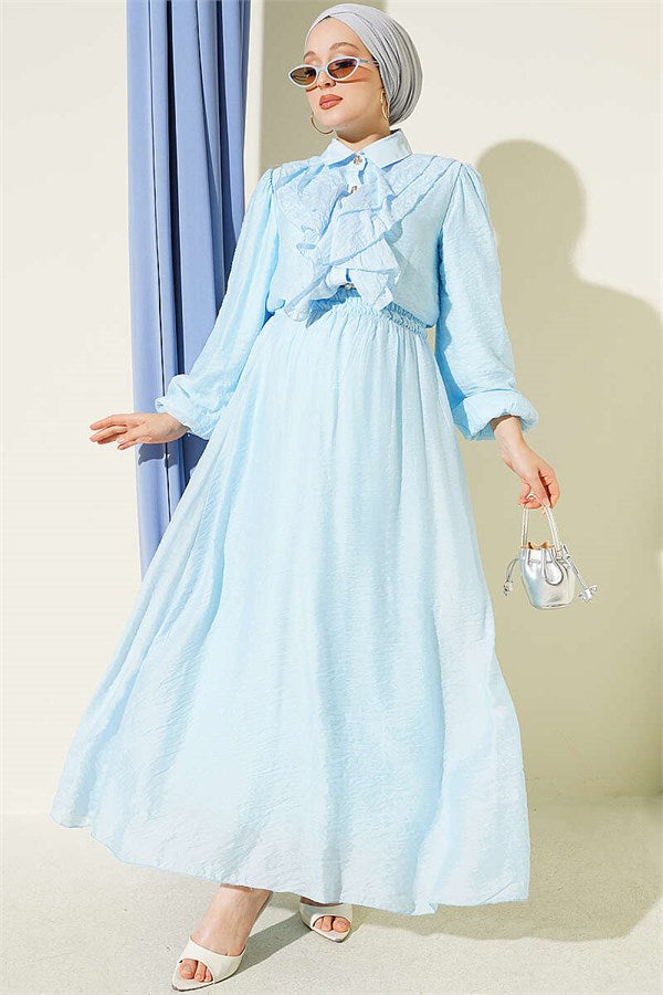 Two-piece set with gold button detail and ruffled skirt, baby blue.
