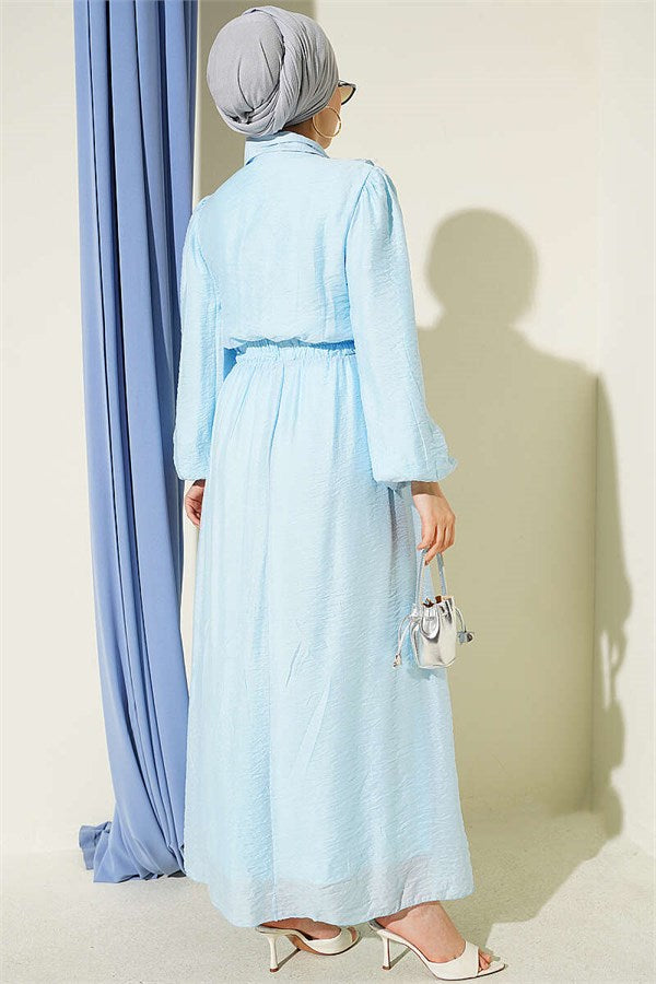 Two-piece set with gold button detail and ruffled skirt, baby blue.