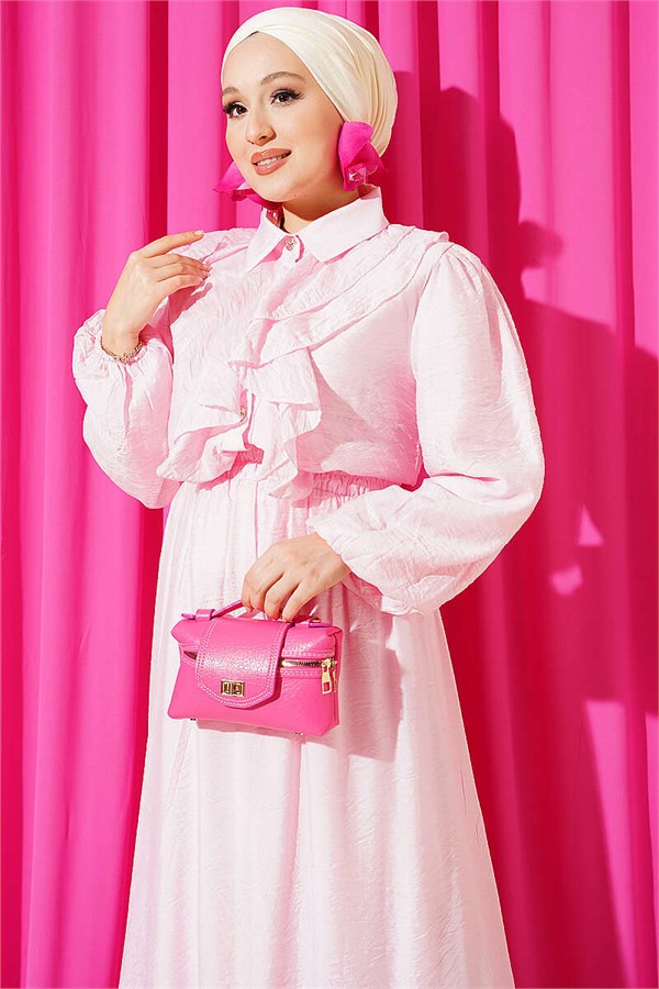 Two-piece set in pink with gold button detail and ruffled skirt.