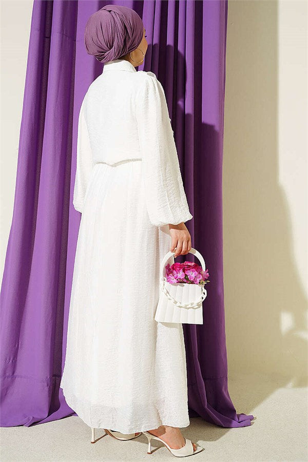 Two-piece set with ruffled skirt and gold button detail, ecru.