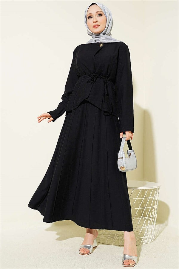 2 Piece Set in black with gold buttons, belt, and pleated skirt.