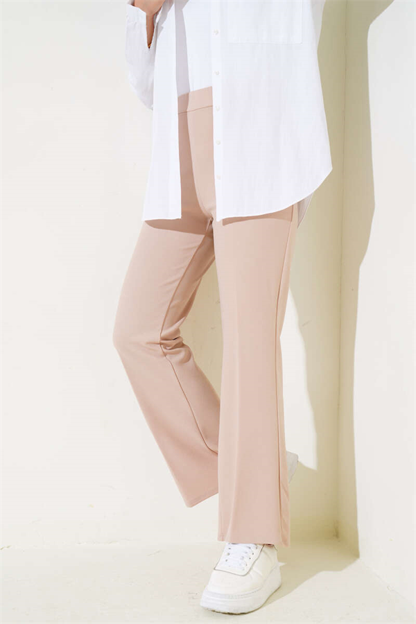 Spanish-style flared double-waisted trousers in beige with elastic waistband.