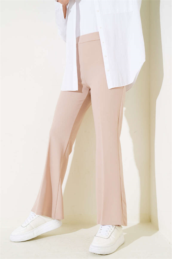 Spanish-style flared double-waisted trousers in beige with elastic waistband.