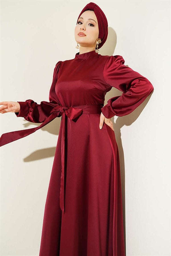 Self-belted satin evening dress in burgundy.