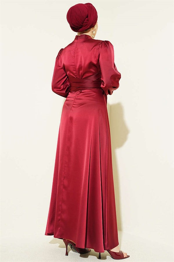 Self-belted satin evening dress in burgundy.
