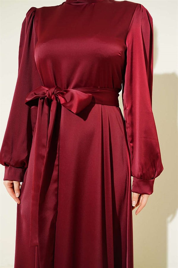 Self-belted satin evening dress in burgundy.