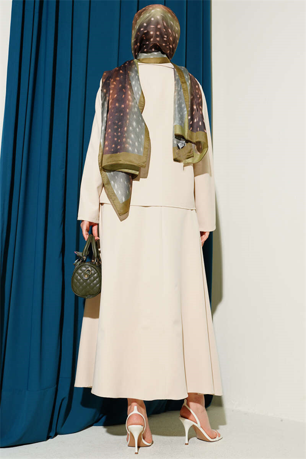 Double-breasted jacket and skirt suit in beige.