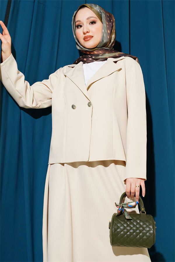 Double-breasted jacket and skirt suit in beige.