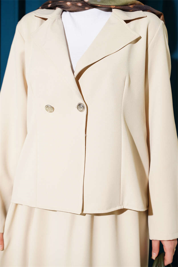 Double-breasted jacket and skirt suit in beige.
