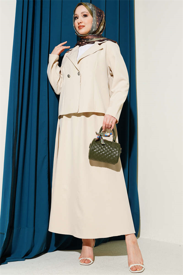 Double-breasted jacket and skirt suit in beige.