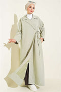 Double-breasted trench coat with drawstring closure, light green.