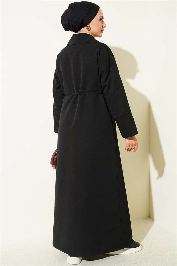Double-breasted trench coat with drawstring closure, black.