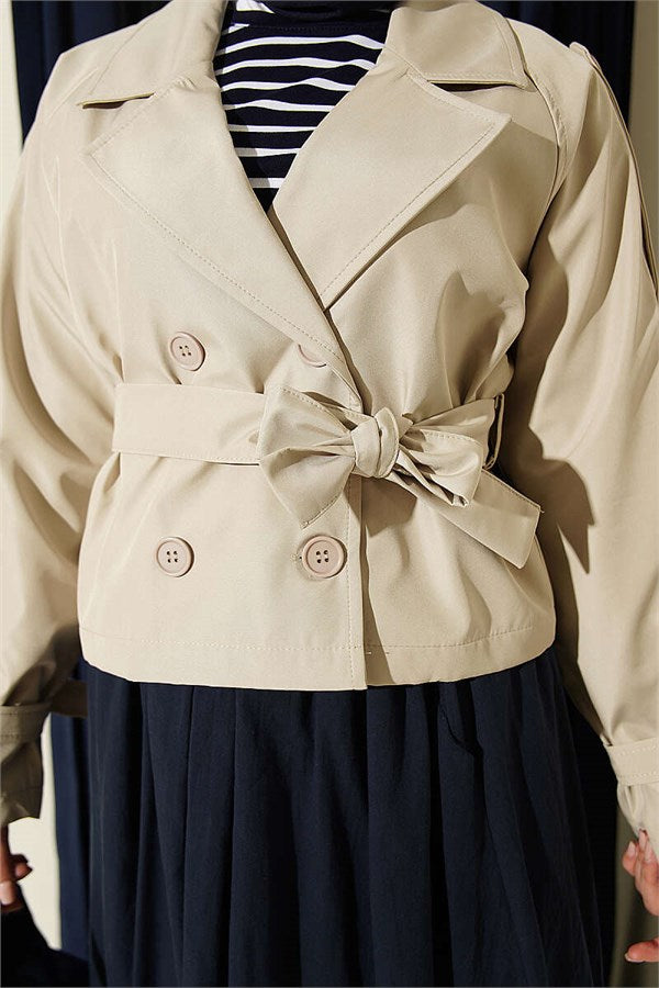 Double-breasted belted short trench coat in stone.