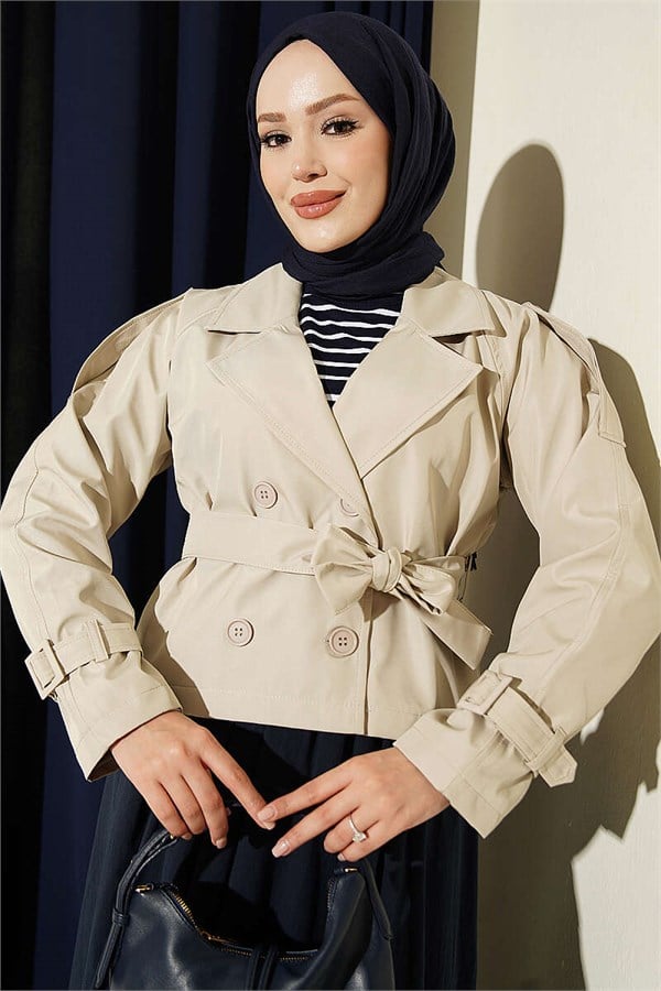 Double-breasted belted short trench coat in stone.