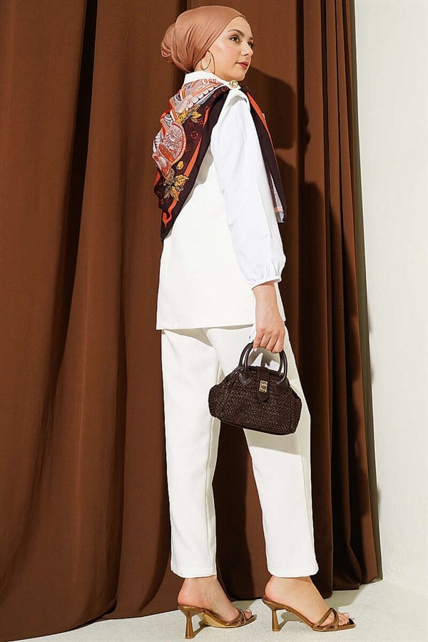 Off-white suit with shoulder epaulets and gold buttons.