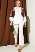 Off-white suit with shoulder epaulets and gold buttons.