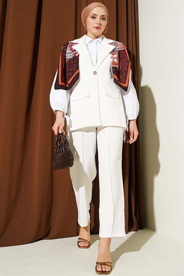 Off-white suit with shoulder epaulets and gold buttons.