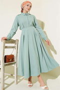 2 Piece Set with pleated skirt and shoulder epaulets, light green.