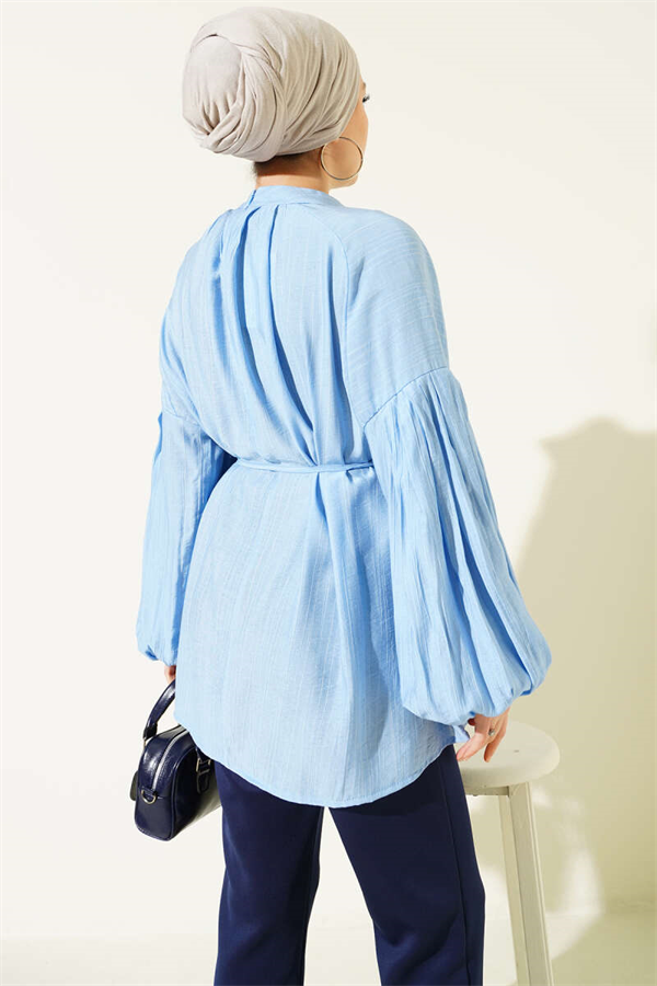 Loose-fitting tunic with shoulder bow, blue.