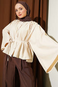 Loose-fitting, oversized short shirt in beige.