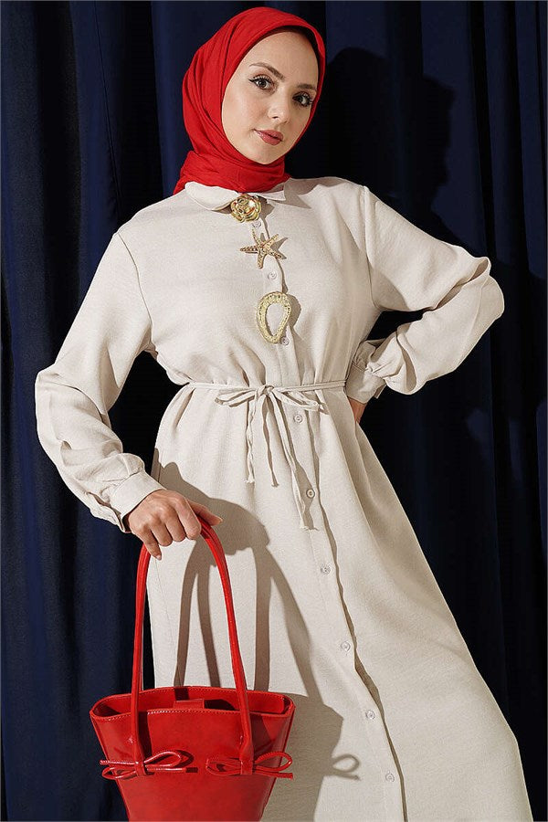 Two-piece set with gold accessories and symbol, beige.