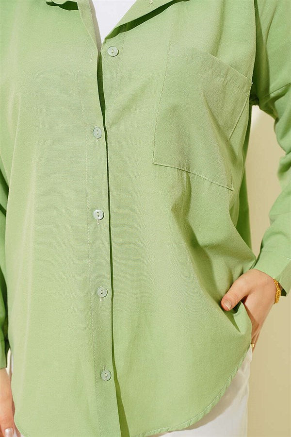 Loose-fitting shirt with one breast pocket, light green.