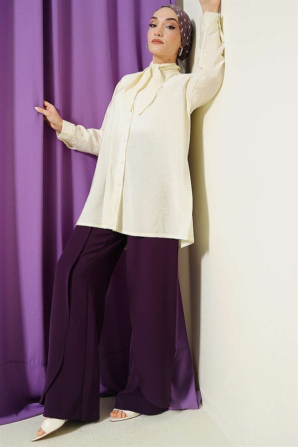 Loose-fitting shirt with tie collar, cream color.