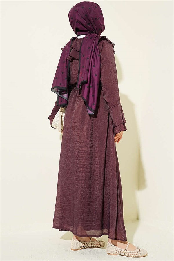 Plum-colored suit with ruffled collar and British-style button-down skirt.