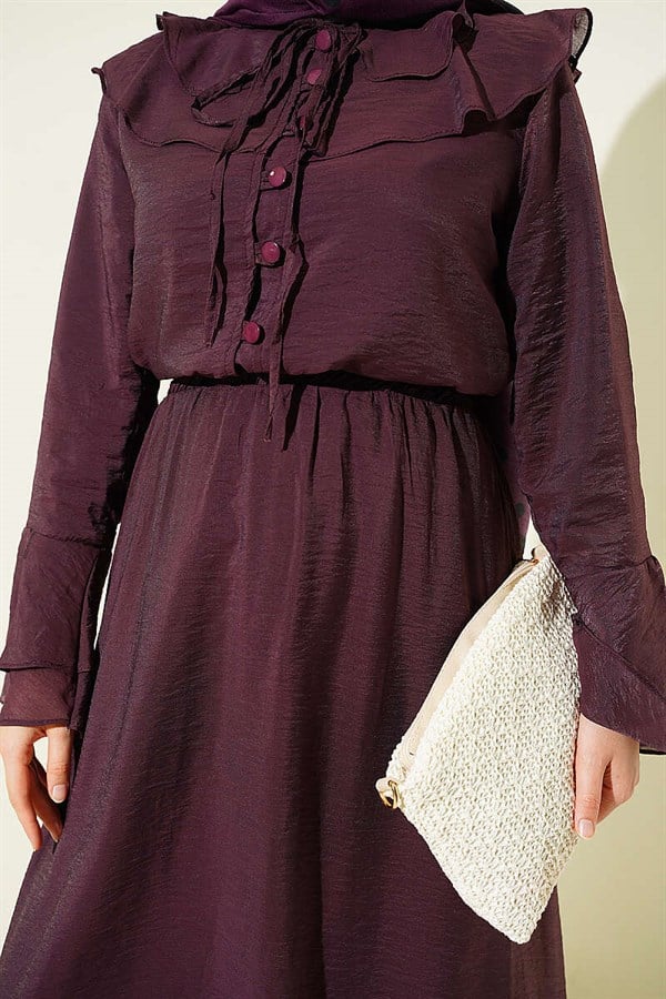 Plum-colored suit with ruffled collar and British-style button-down skirt.
