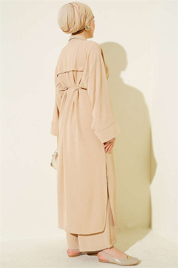 Two-piece set in beige with long tunic and star-shaped accessories.